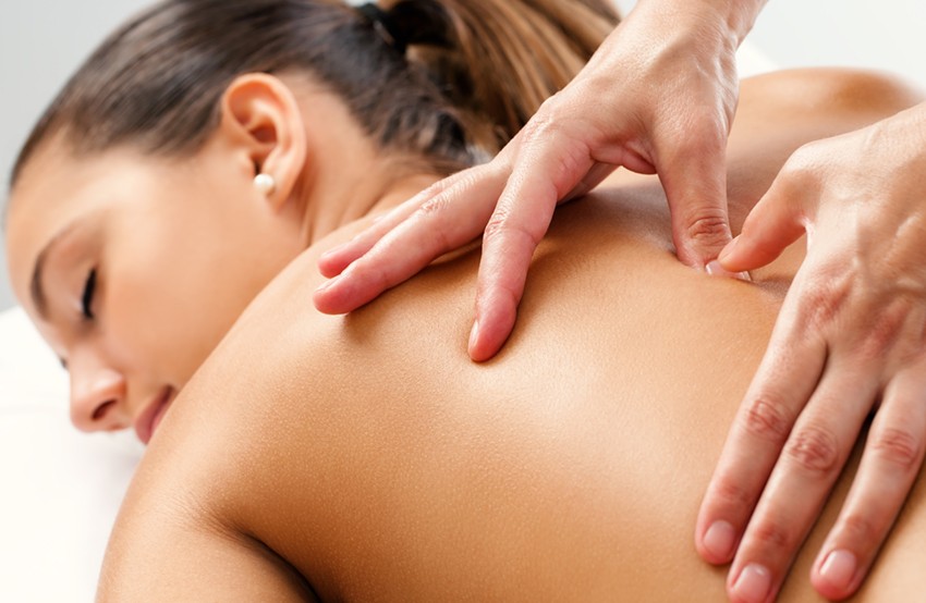 Massage therapist doing therapy to a woman